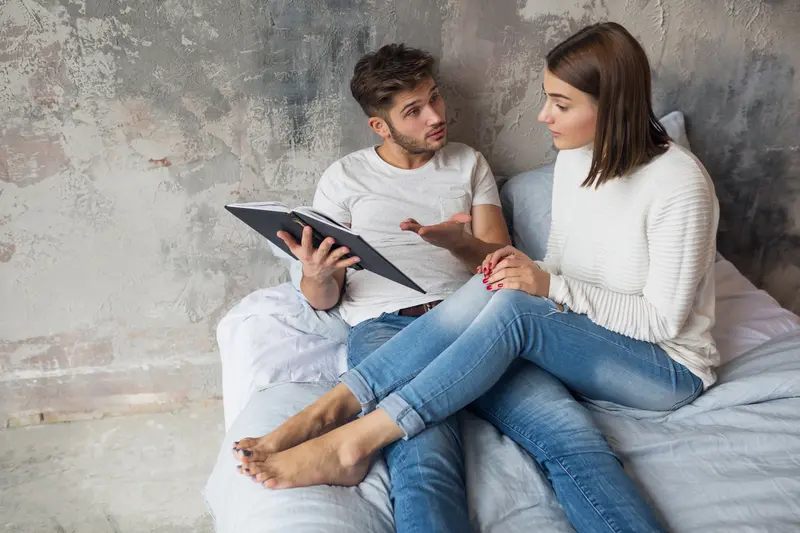 Minimalist illustration of a couple reviewing a compatibility checklist, shown as a calm system blueprint.