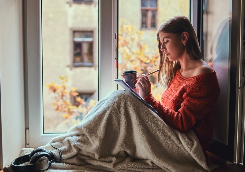 A person gazing out a window with an abstract network overlay, representing mind-wandering and inner narrative.