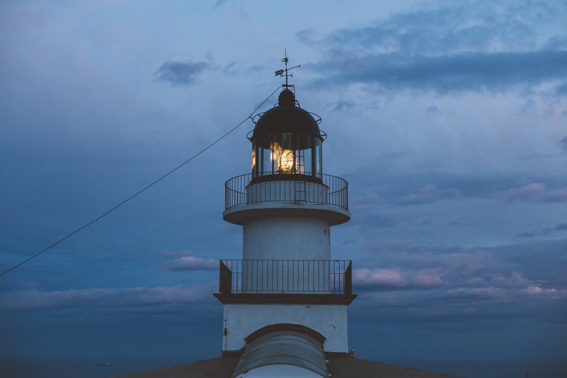 A minimalist lighthouse beam cutting through fog and gentle static noise, symbolizing hope returning in a noisy world